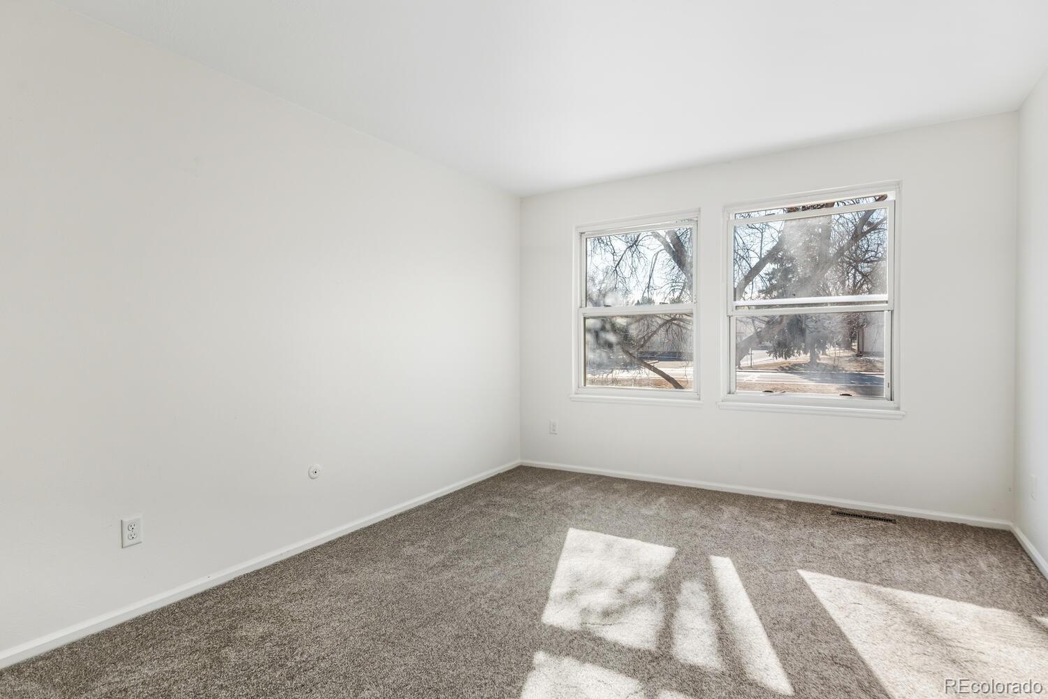 9041 Zephyr Court Broomfield, CO 80021 - Photo 28 of 35 an empty room with windows
