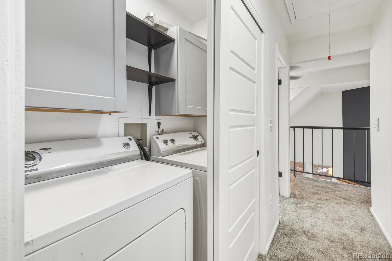 9041 Zephyr Court Broomfield, CO 80021 - Photo 30 of 35 a view of storage and utility room with washer and dryer