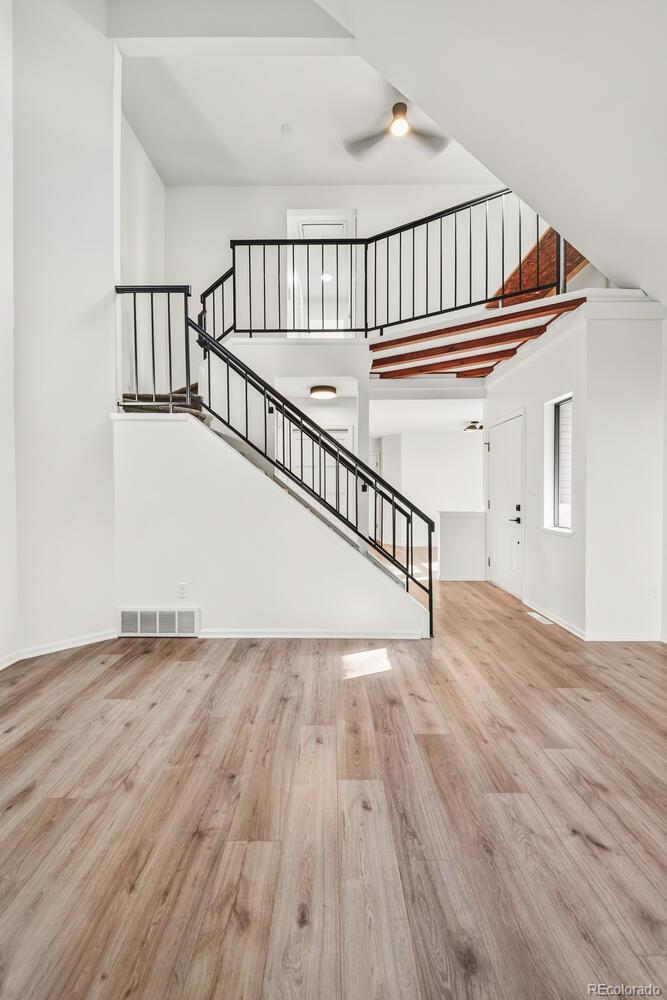 9041 Zephyr Court Broomfield, CO 80021 - Photo 4 of 35 a view of staircase with white walls and a window