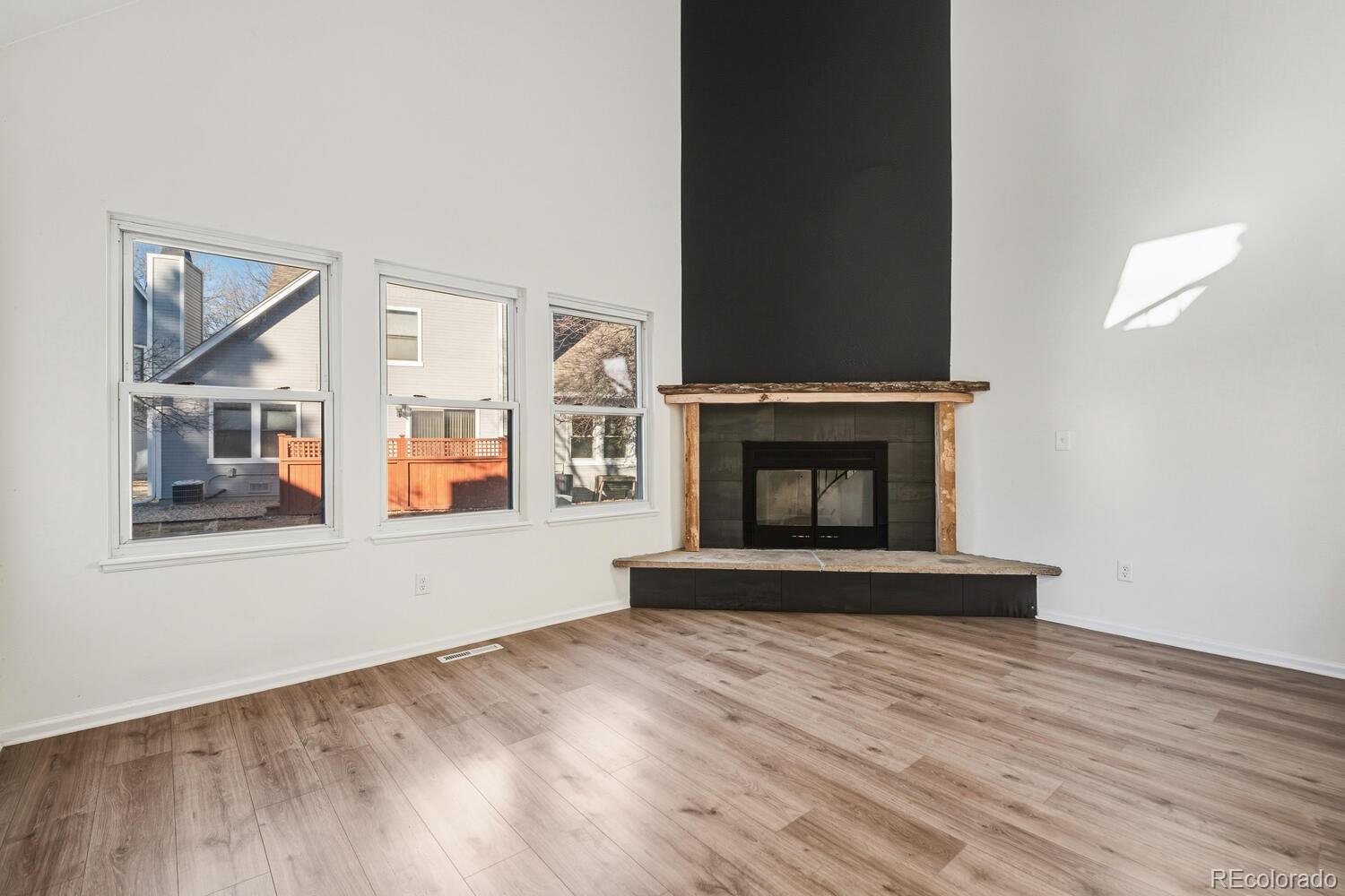 9041 Zephyr Court Broomfield, CO 80021 - Photo 5 of 35 a view of an empty room with wooden floor and a window