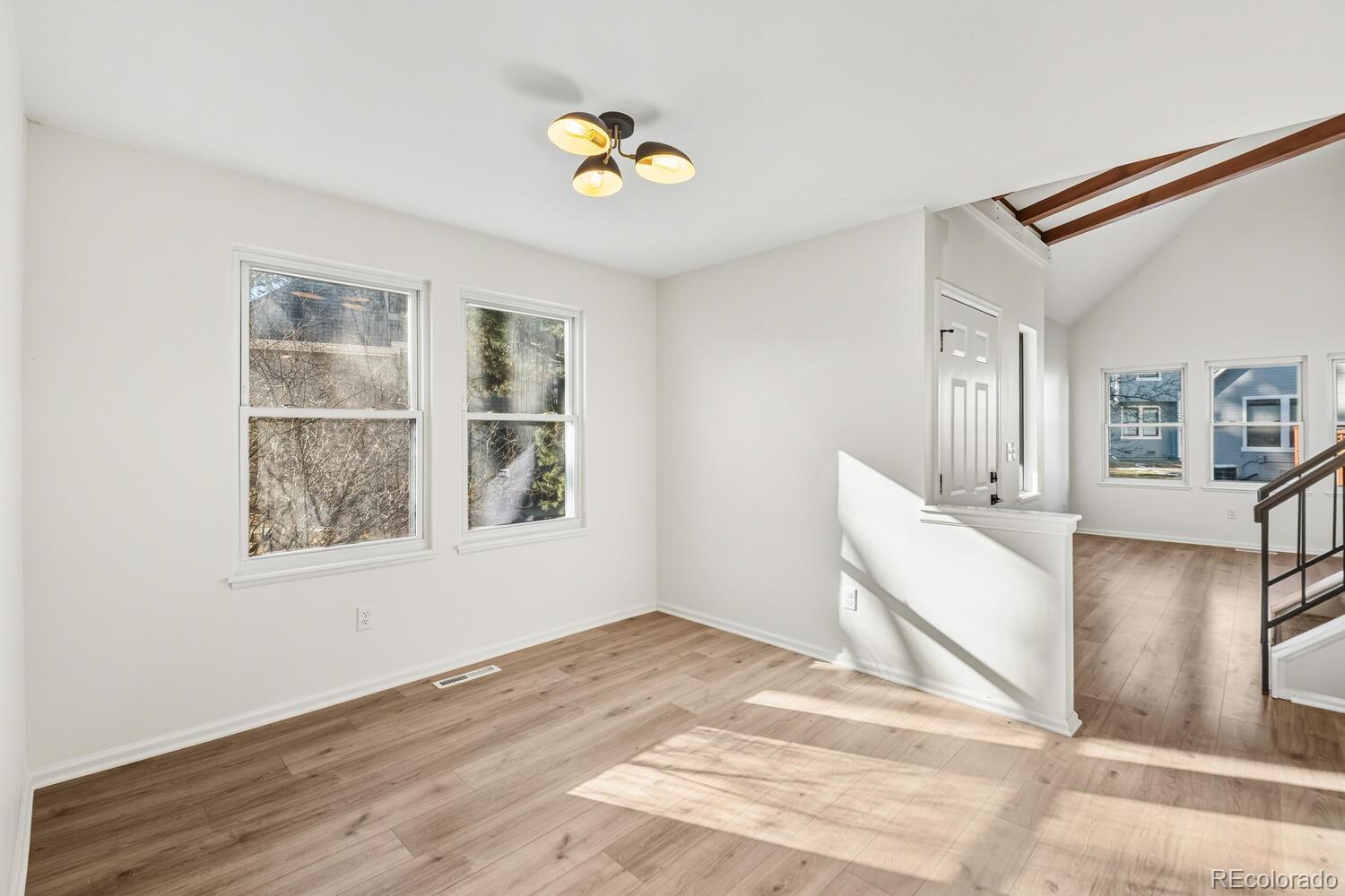 9041 Zephyr Court Broomfield, CO 80021 - Photo 9 of 35 a view of an empty room with window and wooden floor