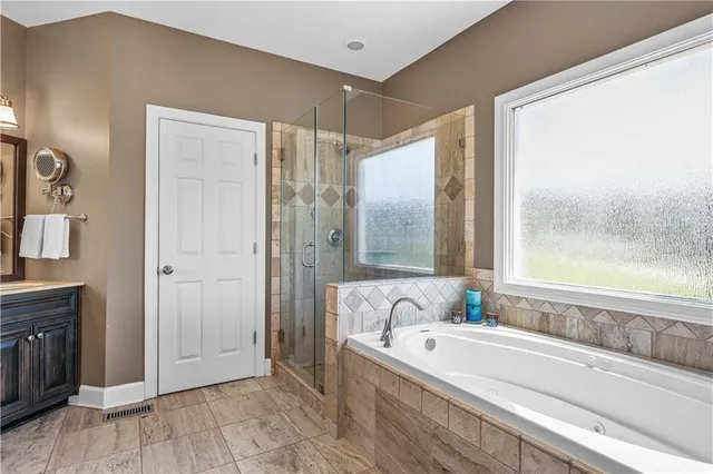 a bedroom with a large bed and a window