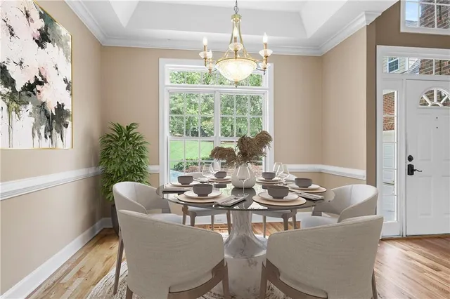 a dining room with furniture a chandelier and wooden floor