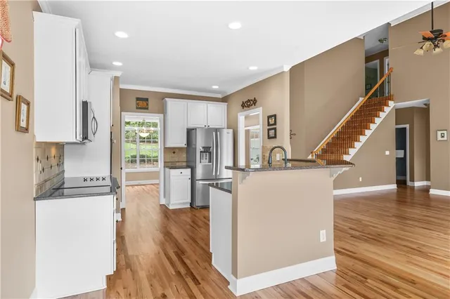 a view of kitchen with furniture and wooden floor