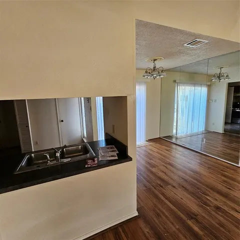 a room with wooden floor and white walls