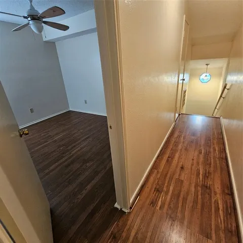 a view of an empty room and wooden floor