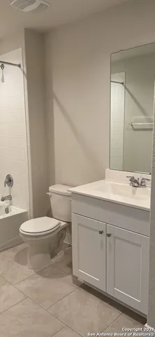 a bathroom with a toilet a sink and bathtub