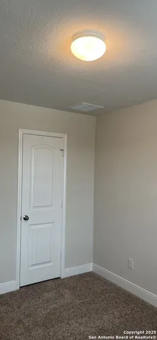 an empty room with closet and window