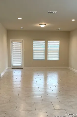 a view of a room with a window and a rug