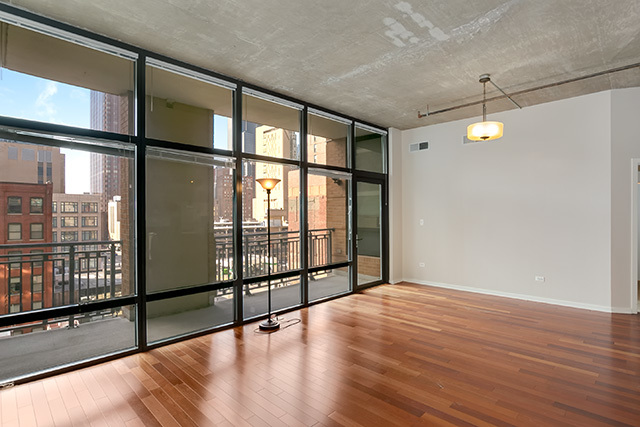 520 South State Street, Unit 711 Chicago, IL 60605 - Photo 8 of 28 a view of an empty room with wooden floor and a window