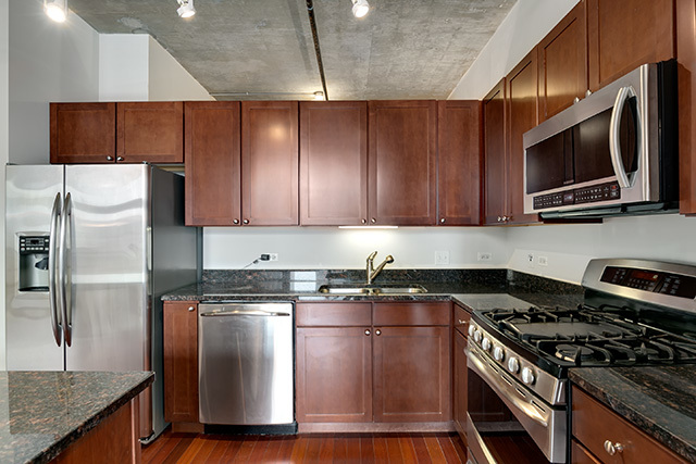 520 South State Street, Unit 711 Chicago, IL 60605 - Photo 10 of 28 a kitchen with stainless steel appliances granite countertop a stove a refrigerator and a microwave