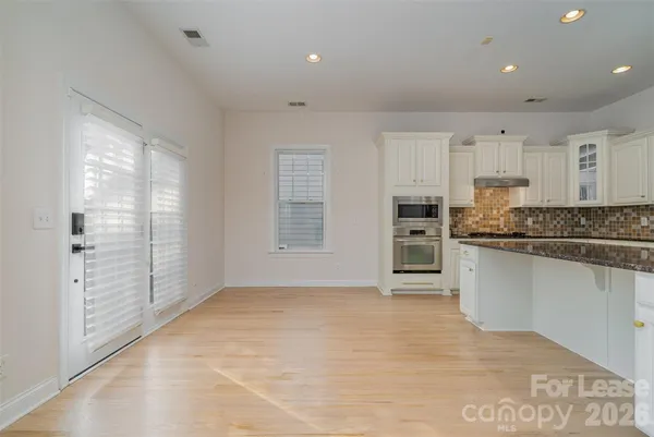 a kitchen with stainless steel appliances granite countertop a refrigerator and a sink