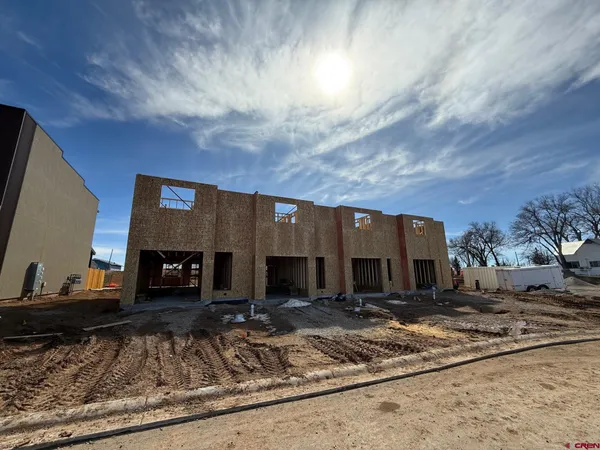 a bathroom with a granite countertop sink a toilet a mirror and shower
