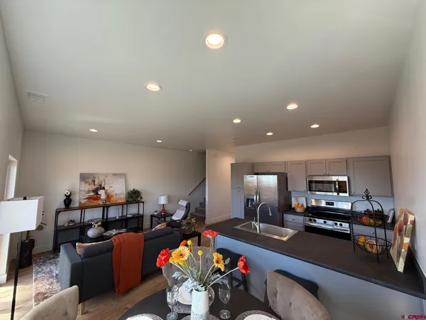 a kitchen with granite countertop a refrigerator and a stove
