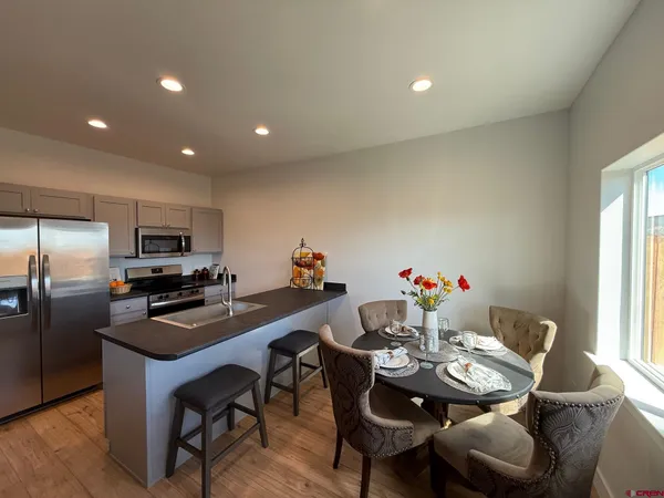 a living room with furniture a window and wooden floor