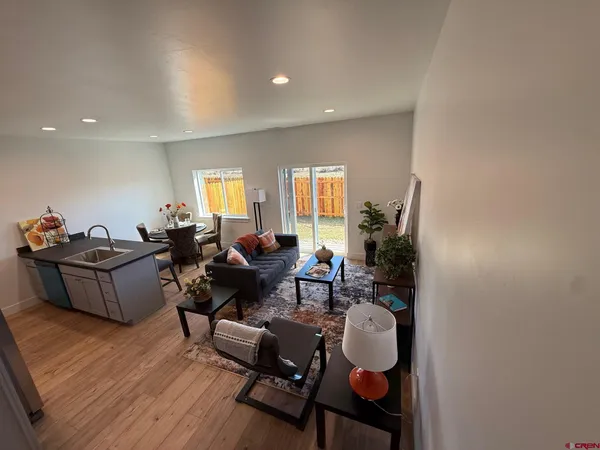 a living room with furniture and a dining table