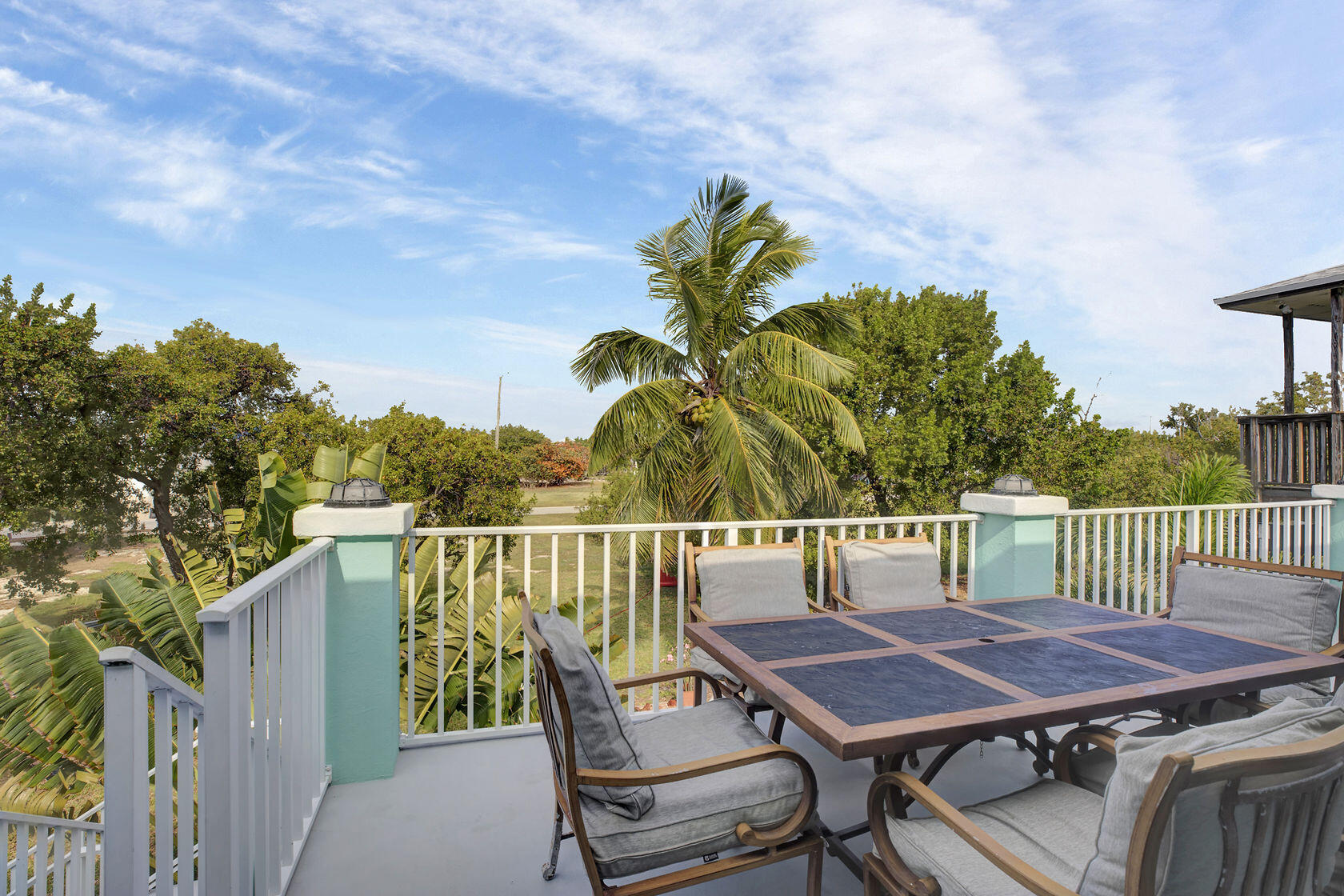 1632 Bogie Drive Big Pine Key, FL 33043 - Photo 33 of 47 a roof deck with a table and chairs with wooden floor and fence