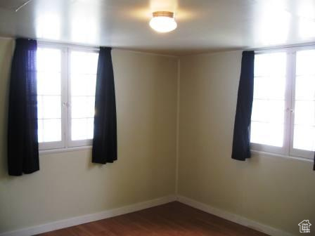 642 East 700 North Logan, UT 84321 - Photo 33 of 33 Empty room with baseboards and dark wood finished floors