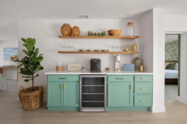 a kitchen with a refrigerator and a more potted plant