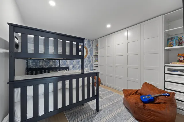 a bedroom with furniture and wooden floor