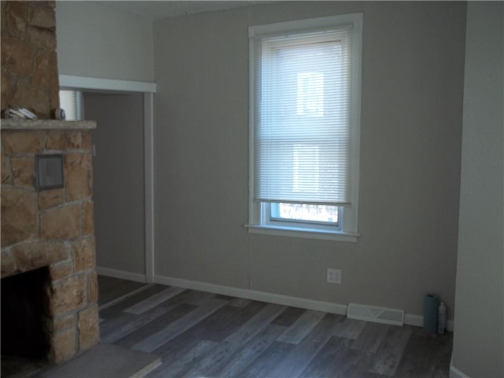 3840 Baytree Street Pittsburgh, PA 15214 - Photo 4 of 21 a room with a fireplace and wooden floor