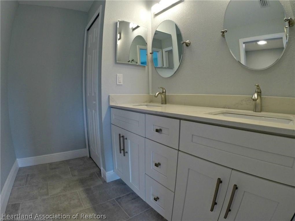 144 Lincoln Road Northwest Lake Placid, FL 33852 - Photo 12 of 19 a bathroom with a double vanity sink and a mirror