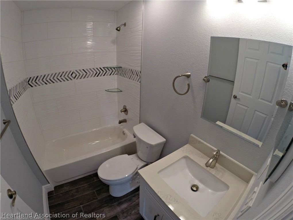 144 Lincoln Road Northwest Lake Placid, FL 33852 - Photo 15 of 19 a bathroom with a sink toilet and shower