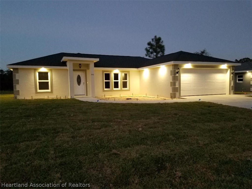 144 Lincoln Road Northwest Lake Placid, FL 33852 - Photo 17 of 19 a view of a house with a yard