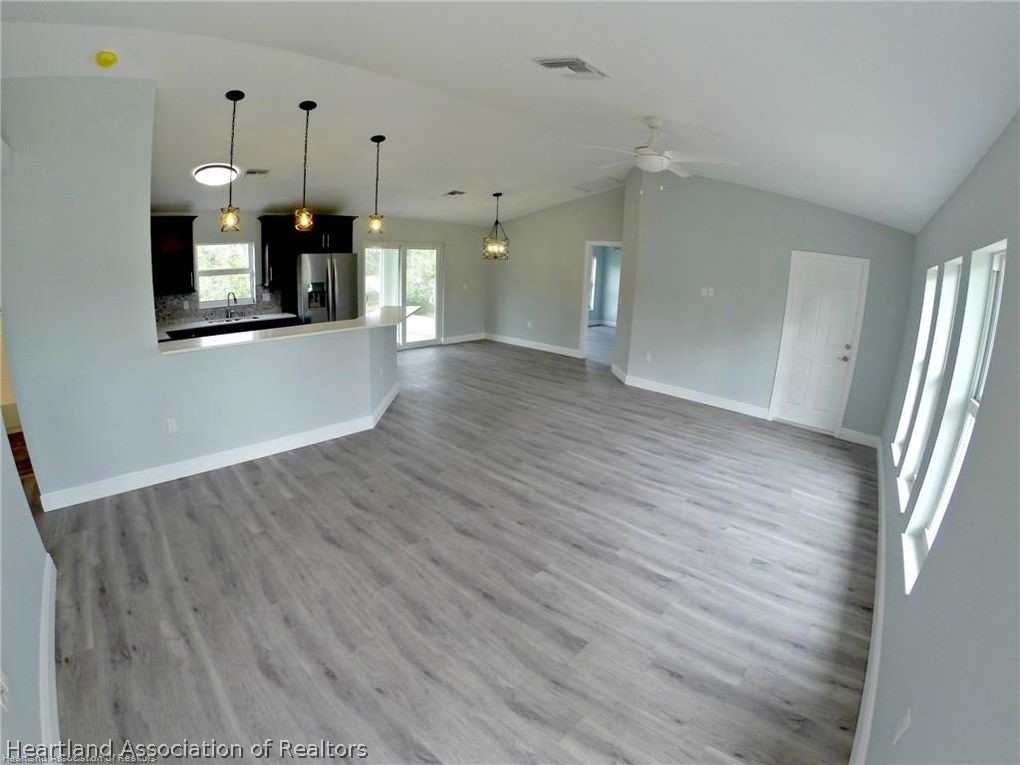 144 Lincoln Road Northwest Lake Placid, FL 33852 - Photo 4 of 19 an empty room with wooden floor and windows