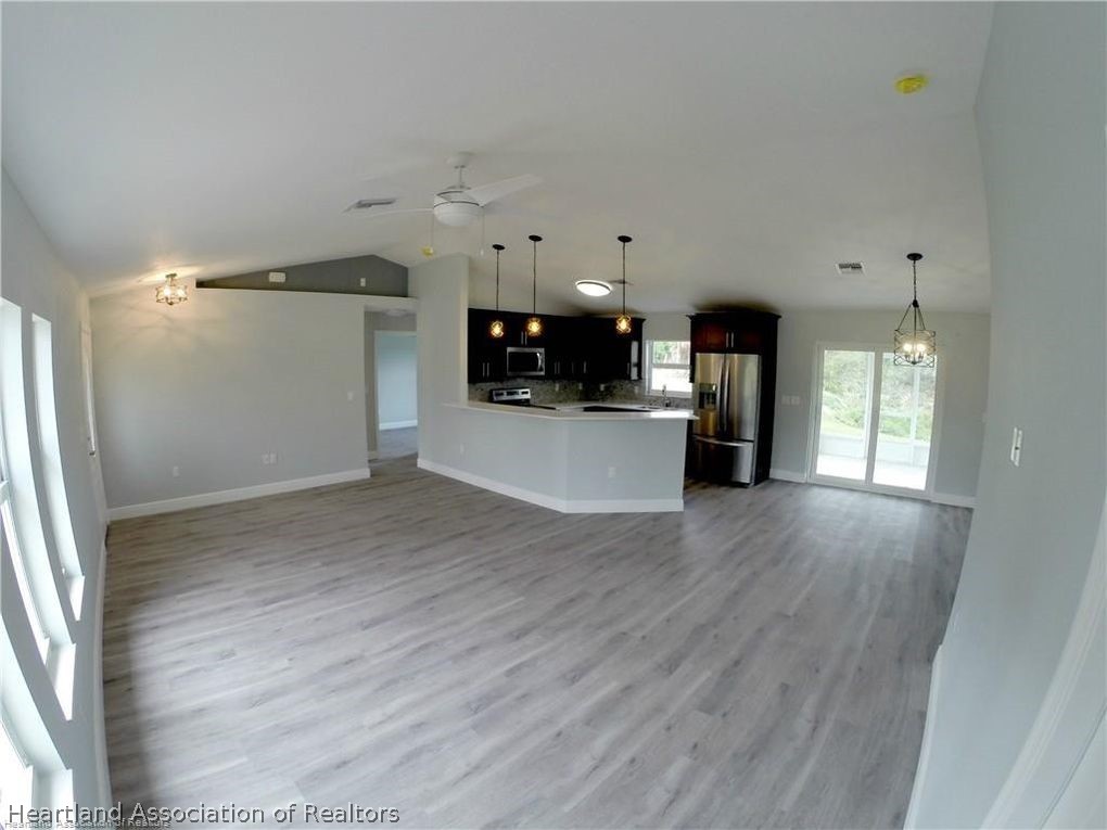 144 Lincoln Road Northwest Lake Placid, FL 33852 - Photo 5 of 19 a view of a electric appliances in kitchen and empty room with wooden floor