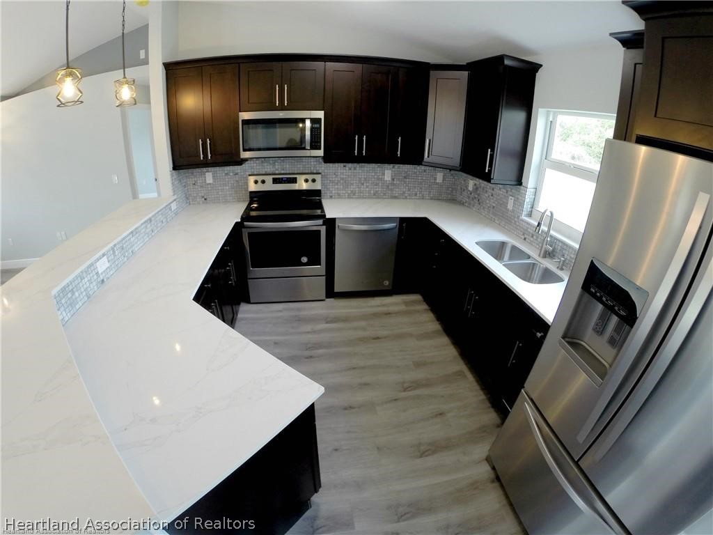 144 Lincoln Road Northwest Lake Placid, FL 33852 - Photo 8 of 19 a kitchen with stainless steel appliances a refrigerator and a stove