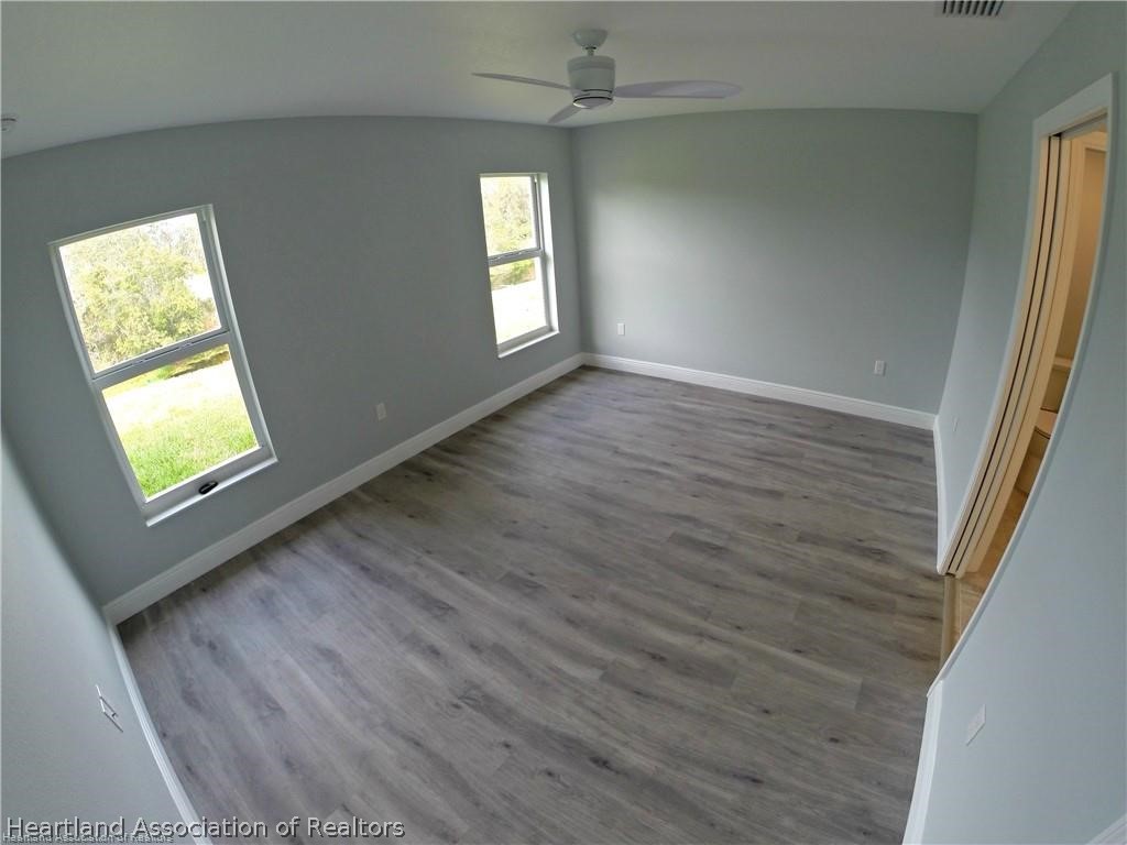 144 Lincoln Road Northwest Lake Placid, FL 33852 - Photo 10 of 19 wooden floor in an empty room with a window