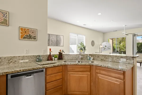 a kitchen with granite countertop a sink and cabinets