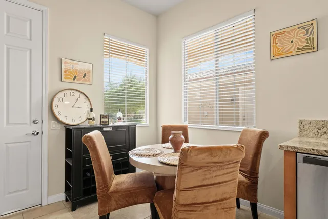 a view of a dining room with furniture and a large window
