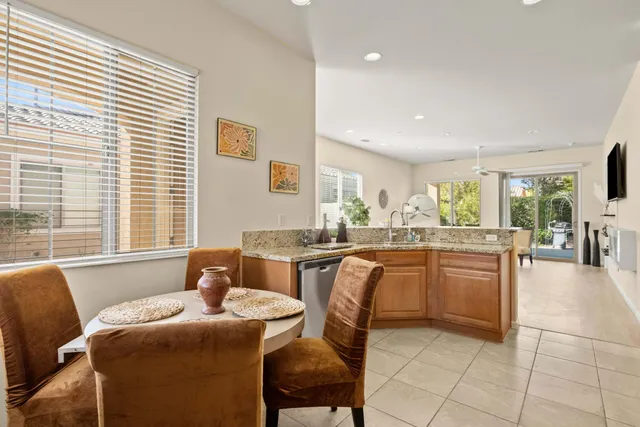 a kitchen with a table chairs sink and cabinets