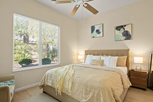 a large bed sitting in a bedroom next to a window