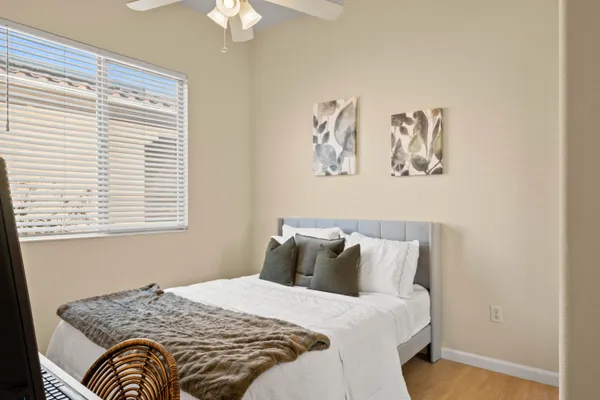 a bedroom with a bed and a window