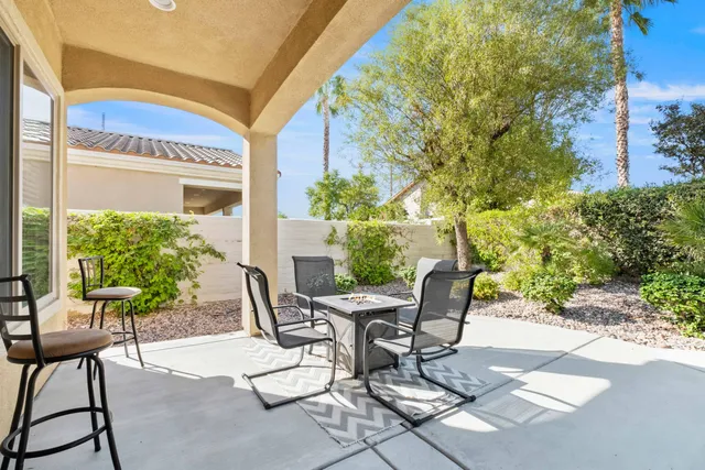 a view of a chairs and table in patio