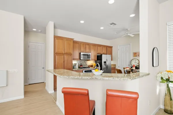 a kitchen with stainless steel appliances granite countertop a sink and refrigerator