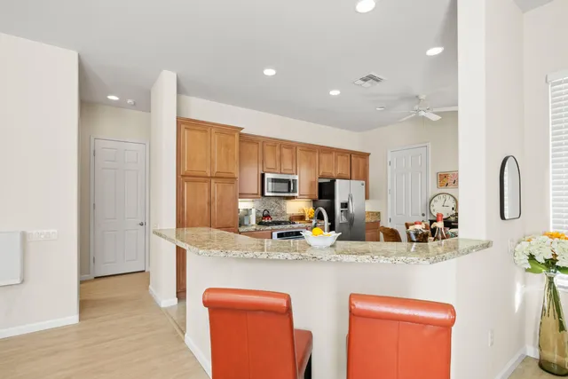 a kitchen with stainless steel appliances granite countertop a sink and refrigerator