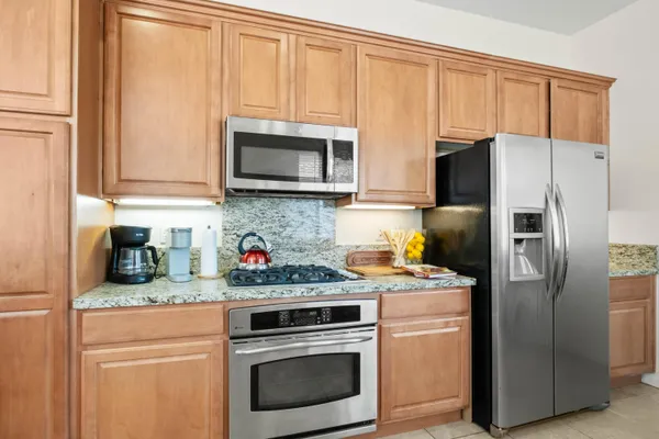 a kitchen with a refrigerator stove and microwave