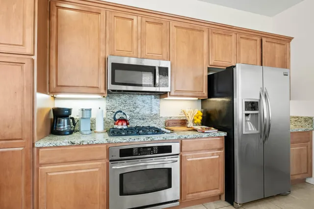 a kitchen with a refrigerator stove and microwave