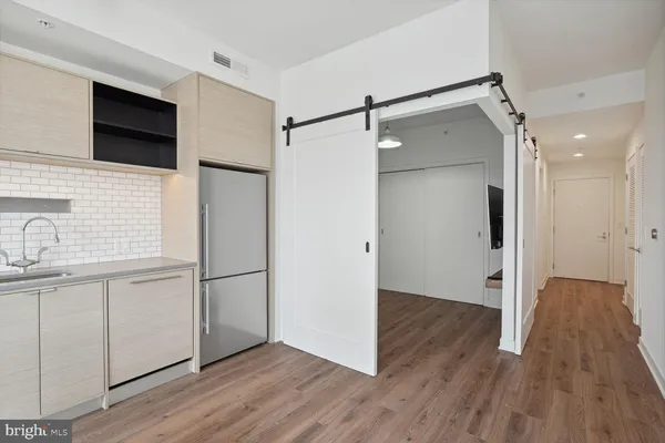 a view of a kitchen with a sink and wooden floor