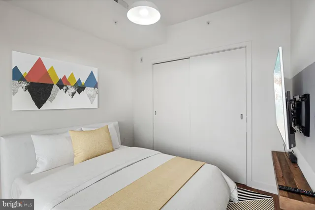 a bedroom with a bed and a flat screen tv