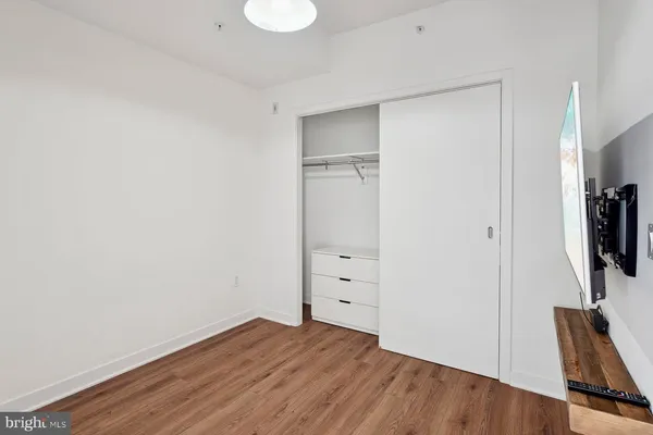 a view of room with wooden floor and a window