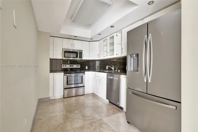 a kitchen with cabinets and stainless steel appliances