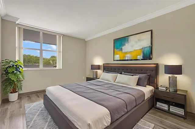 a bedroom with a bed and a potted plant