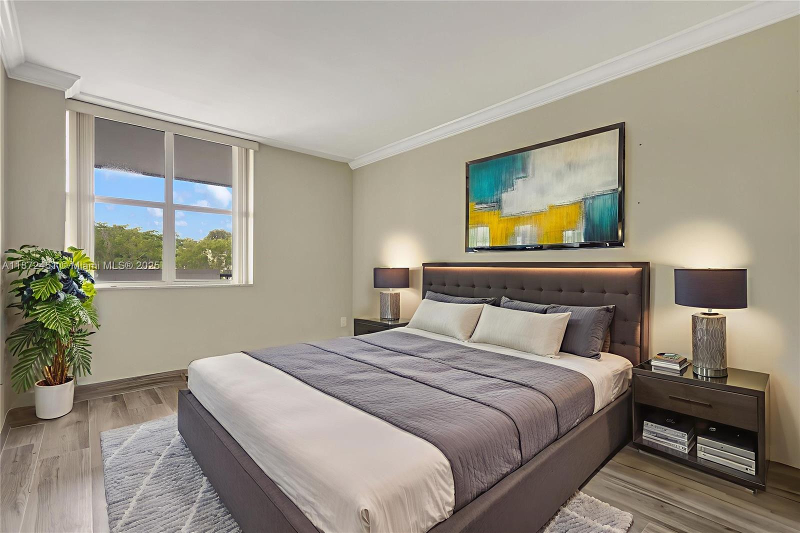 20100 West Country Club Drive, Unit 204 Aventura, FL 33180 - Photo 14 of 25 a bedroom with a bed and a potted plant