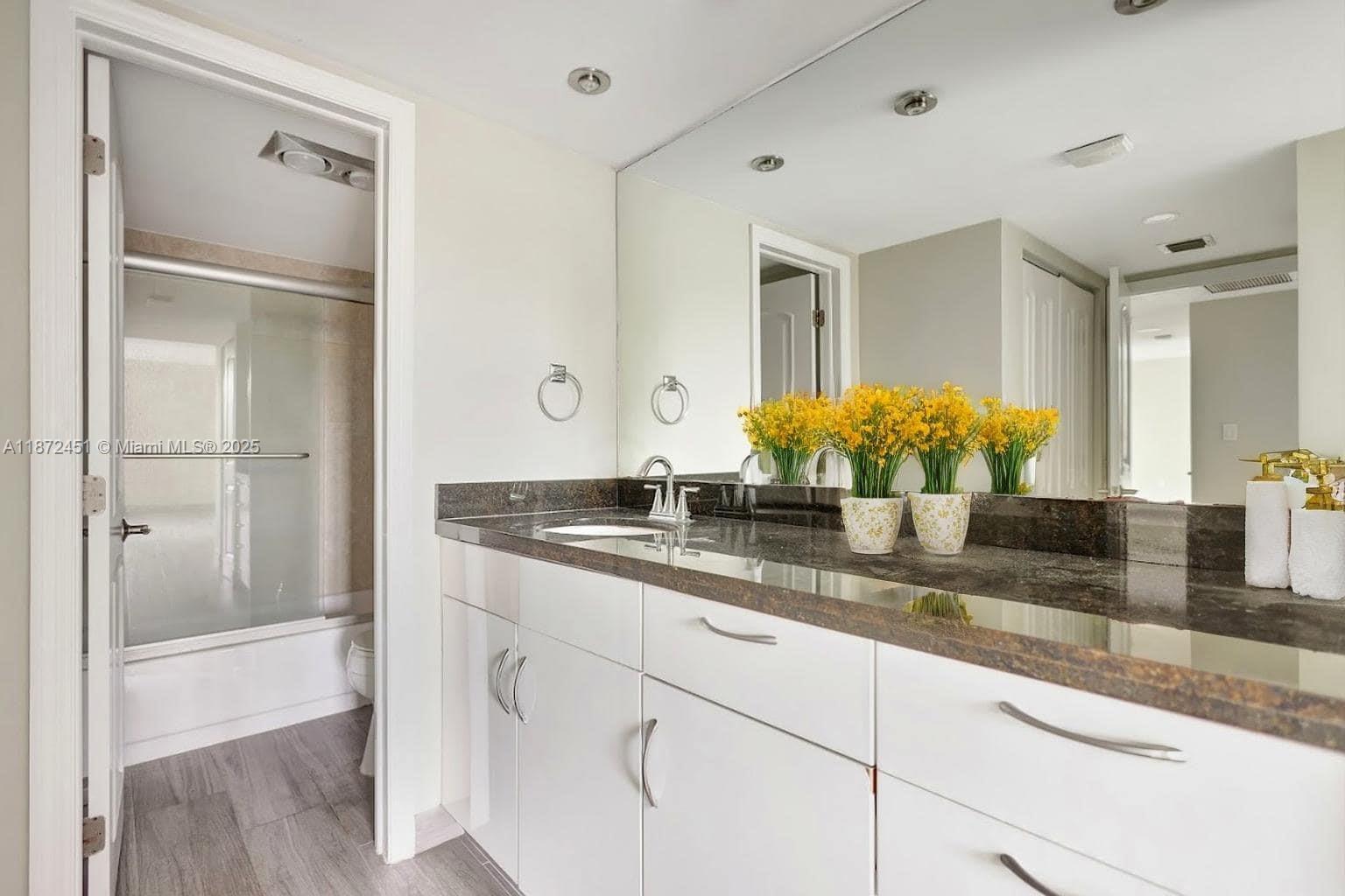 20100 West Country Club Drive, Unit 204 Aventura, FL 33180 - Photo 17 of 25 a bathroom with sink and mirror