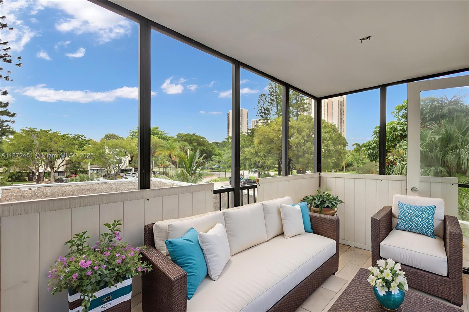 20100 West Country Club Drive, Unit 204 Aventura, FL 33180 - Photo 19 of 25 a living room with furniture and a potted plant